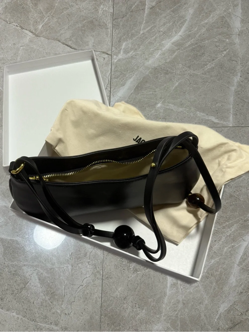 Sleek Black Leather Shoulder Bag with Beaded Strap Accent